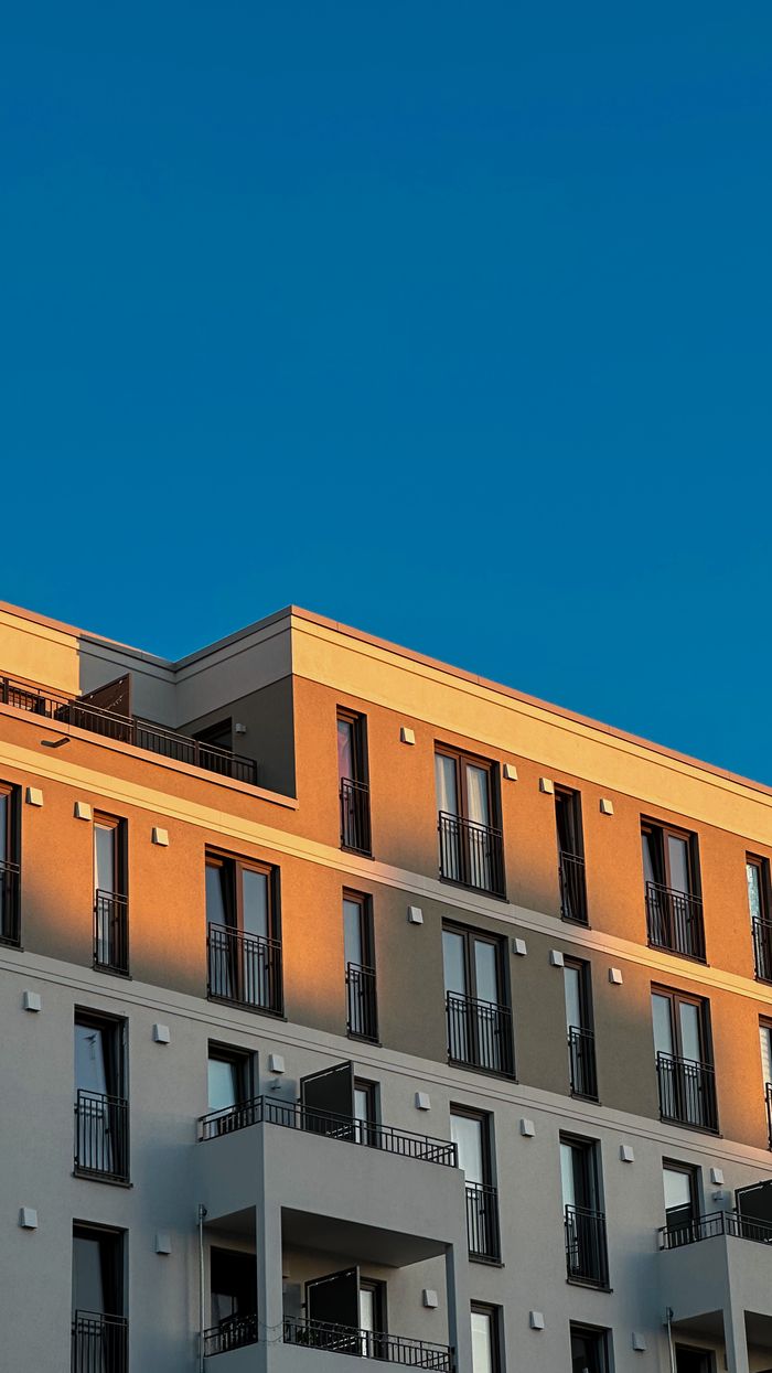 Contemporary Berlin apartment building under a clear blue sky.